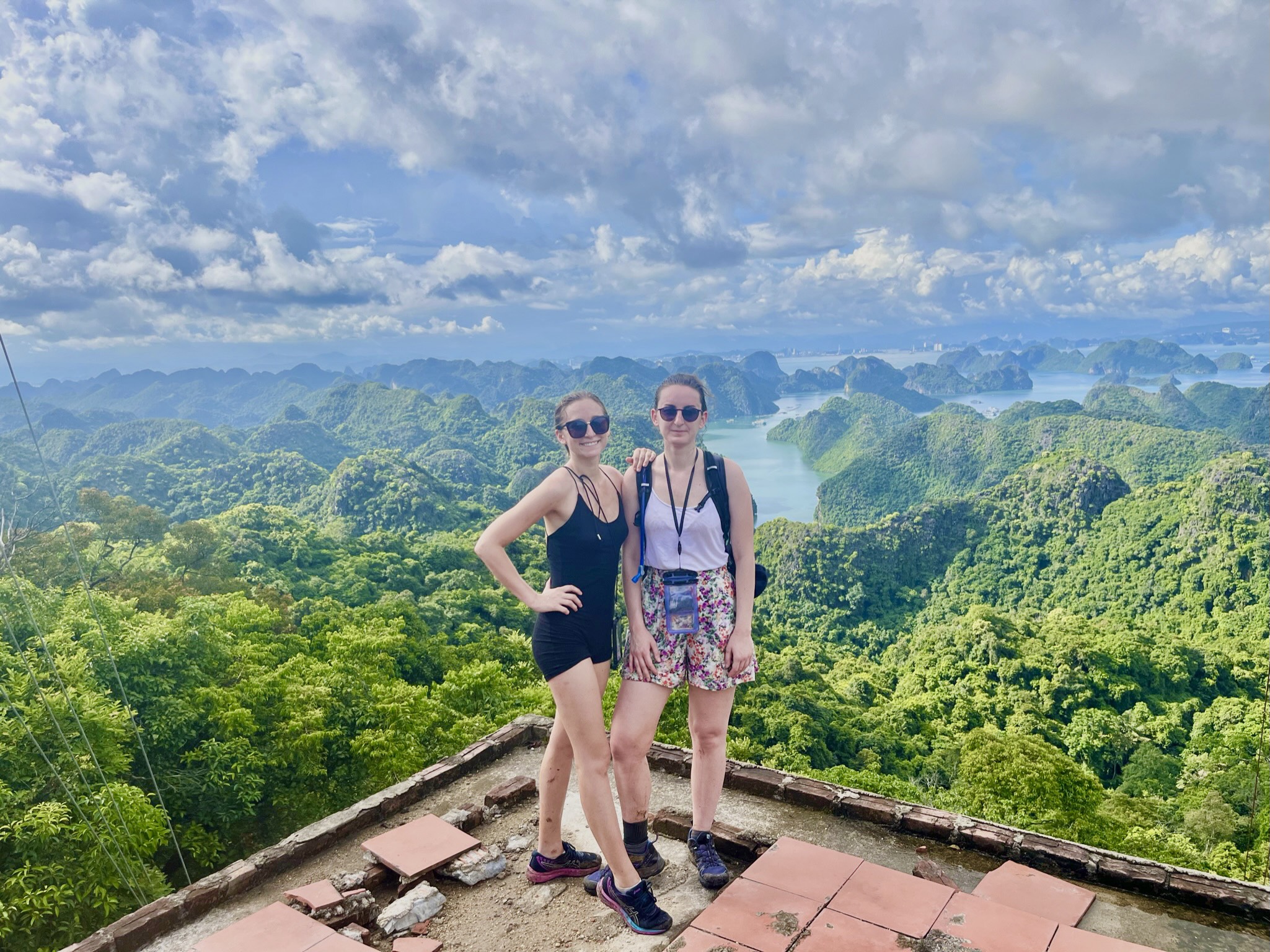 Solo female traveller standing at a jungle viewpoint overlooking Cat Ba National Park