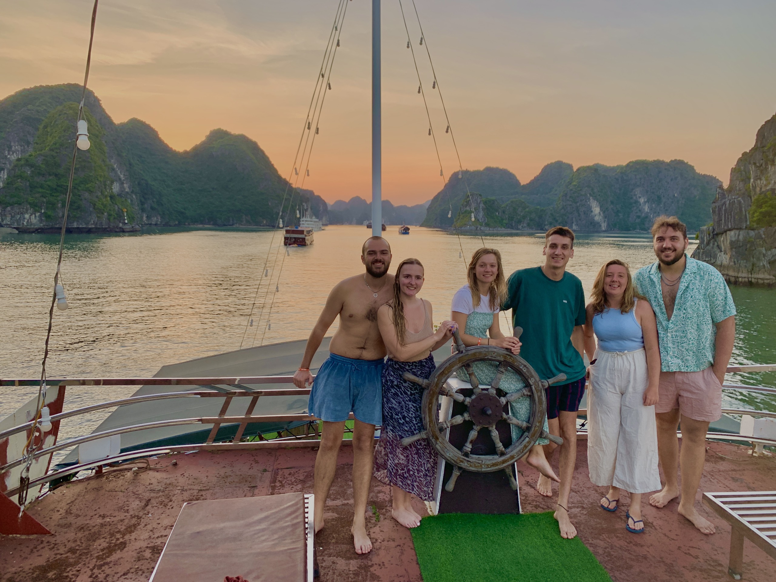 Group of travellers on the deck of a boat crossing Lan Ha Bay