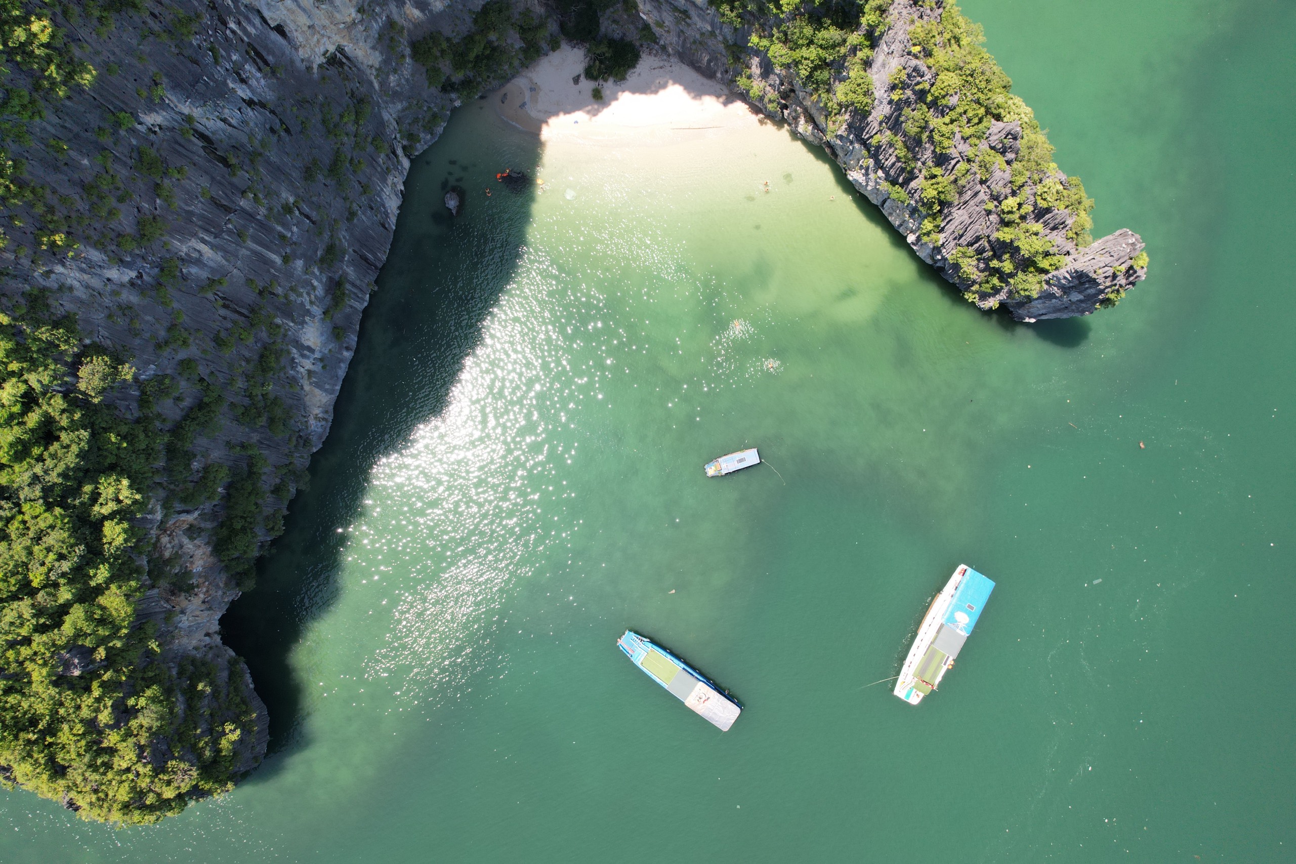 Turquoise water and small boats seen from above in Lan Ha Bay near Viet Hai Village, Cat Ba Island