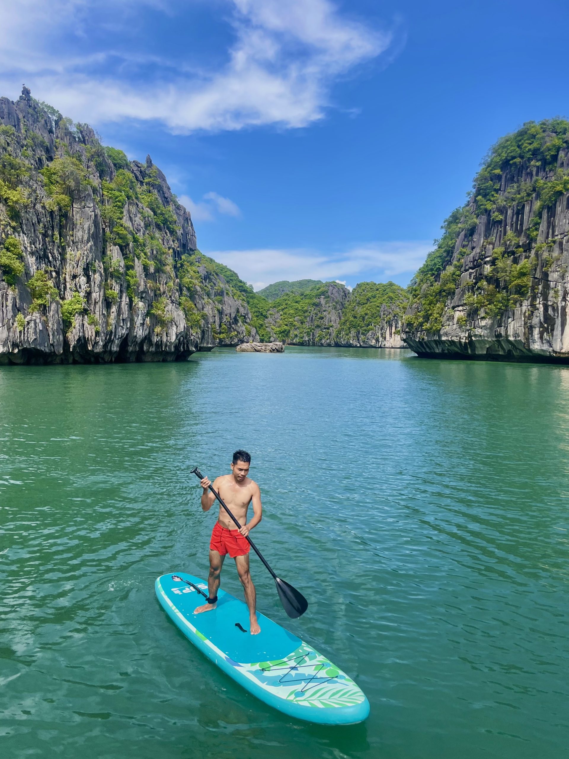 Stand-up paddleboarding between dramatic limestone cliffs in Lan Ha Bay