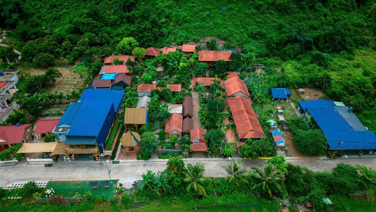 Aerial view over the rooftops of Viet Hai Village surrounded by jungle, Cat Ba National Park