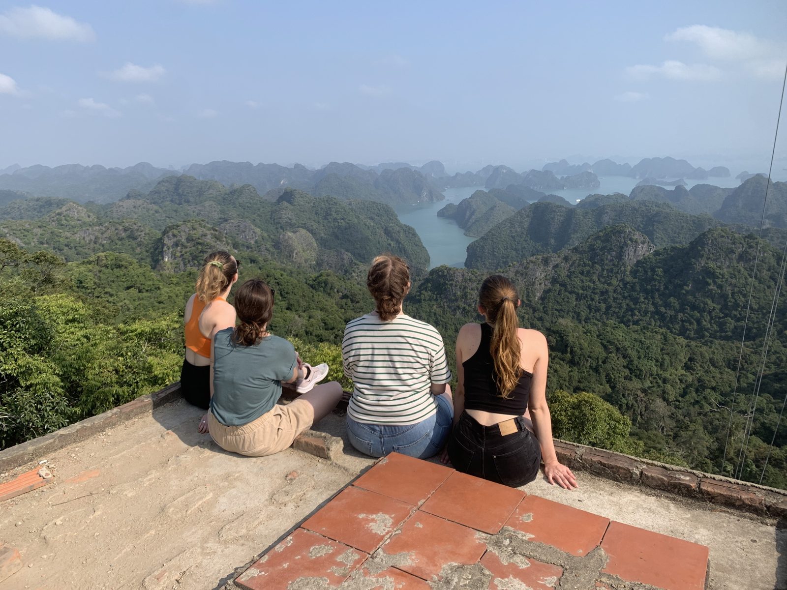 Travellers on the concrete viewpoint platform looking over Lan Ha Bay from Cat Ba National Park