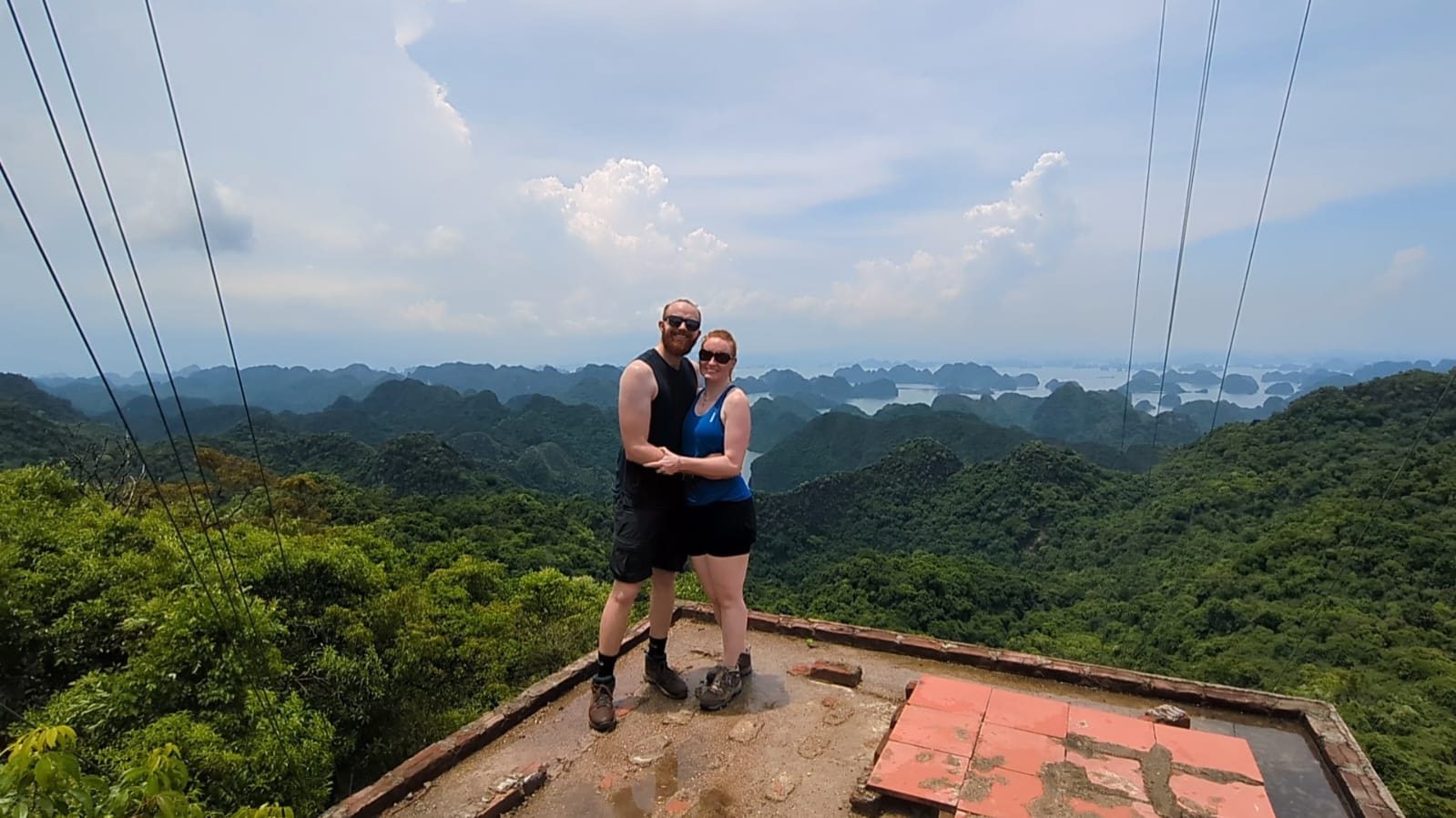 Couple standing at a jungle viewpoint over the bay, Cat Ba Island