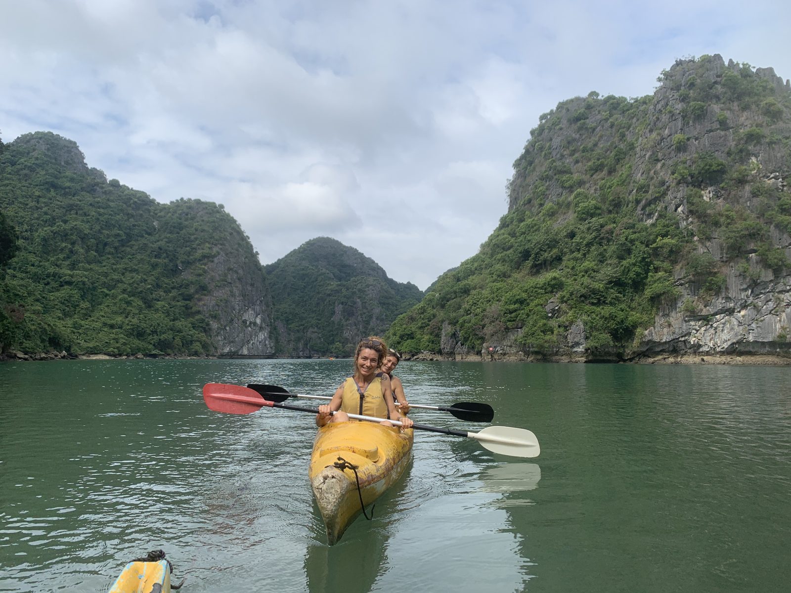Couple kayaking together on calm water in Lan Ha Bay