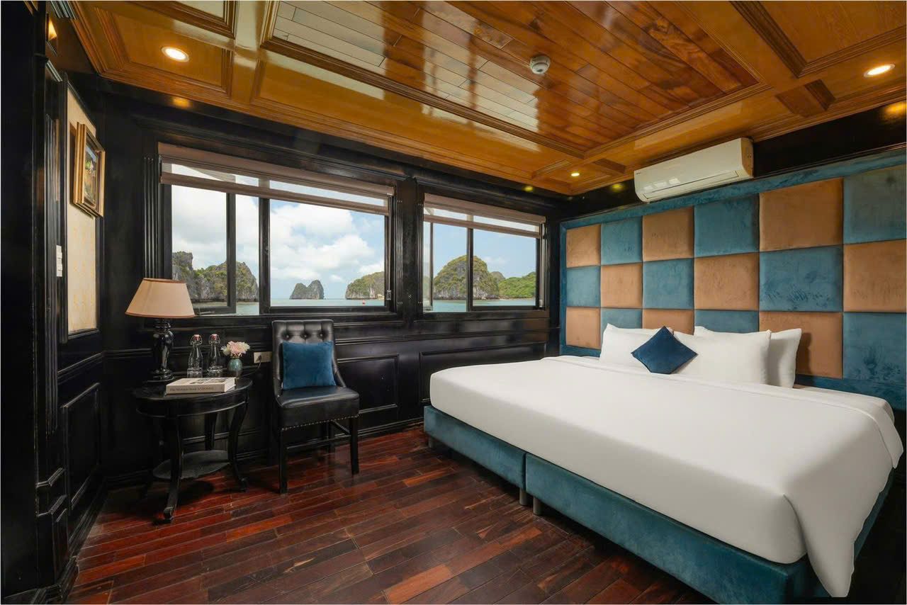 Double bed in a wooden cruise cabin overlooking Lan Ha Bay
