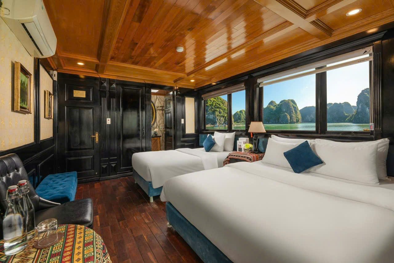 Cruise cabin with a writing desk and a view over Lan Ha Bay