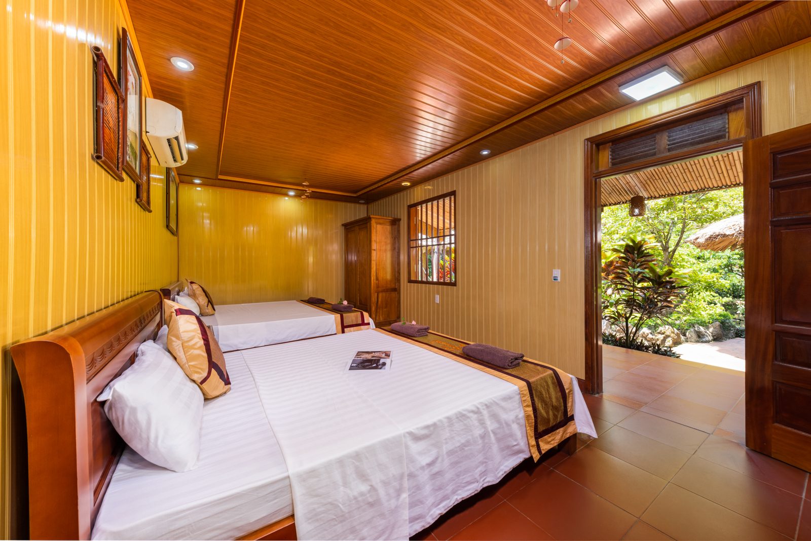 Wooden double room interior with window at Lan Homestay, Viet Hai Village
