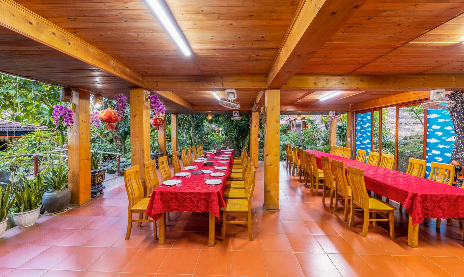Guests eating together at the long shared dinner table at Lan Homestay, Viet Hai Village