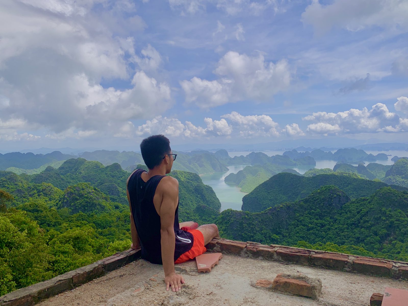 Traveller looking out over the limestone karsts from a Cat Ba viewpoint