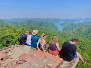 Travellers sitting on the Ngu Lam Peak viewing platform above Lan Ha Bay, Cat Ba National Park