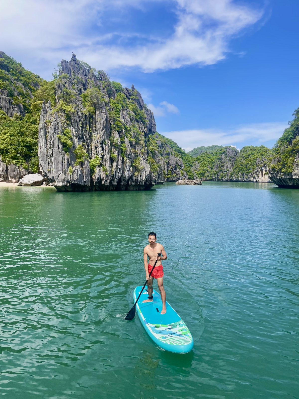 Stand-up paddleboarding on turquoise water in Lan Ha Bay