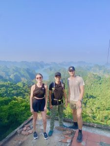 Three hikers at the Ngu Lam Peak viewpoint, Cat Ba National Park