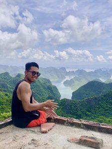 Traveller sitting at a viewpoint above Cat Ba National Park