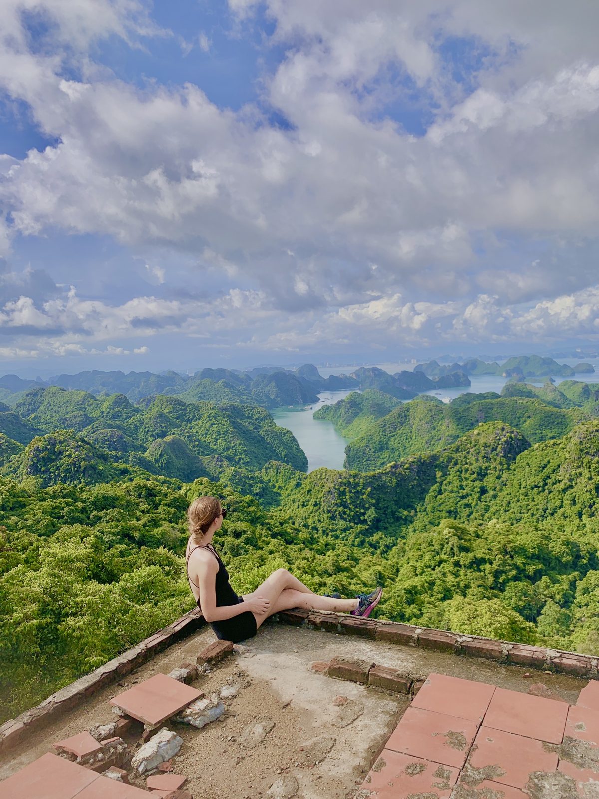 Woman sitting at a jungle viewpoint in Cat Ba National Park