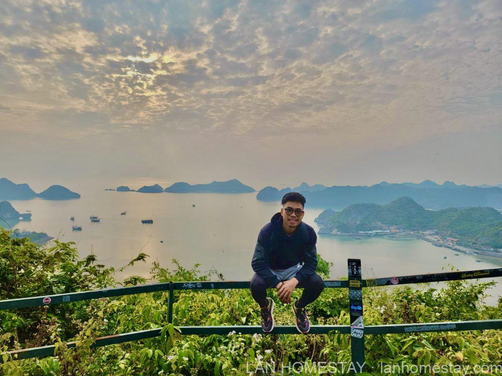 Chilly, founder of Lan Homestay, at a viewpoint above Lan Ha Bay